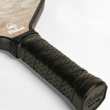 Close-up of a pickleball paddle with black grip and visible brand logo on a light gray background