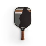 Pickleball paddle with a black face and brown handle on a white background