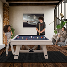 Three people playing pool in a modern living room.