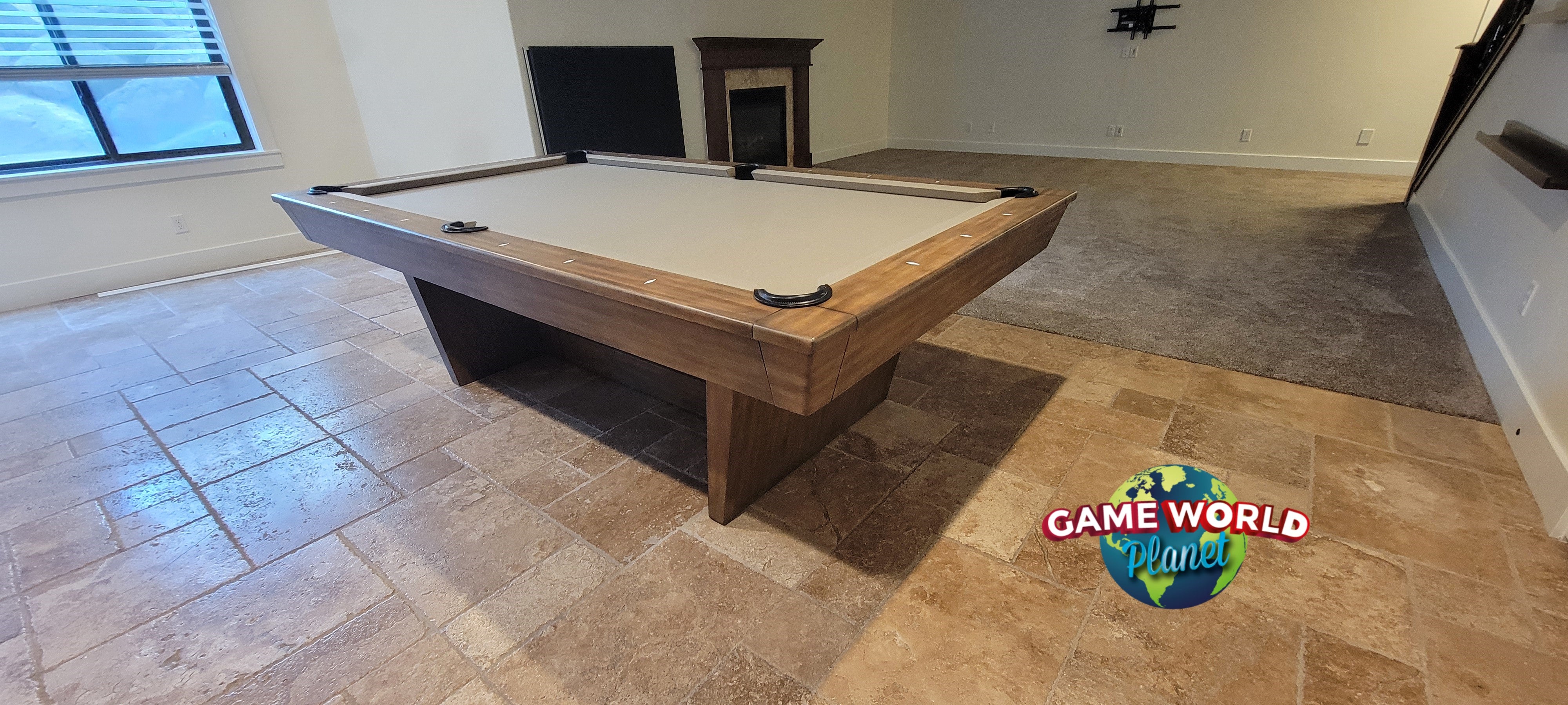 Nixon Billiards KAI 8' Slate Pool Table in walnut finish, shown in a tiled room with fireplace.