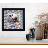 Framed picture of a football helmet with 'Patriots' branding on a desk against a white brick wall.