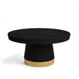 Black round dining table with a gold base on a white background