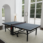 The Kettler Pro Indoor 15 Table Tennis Table sits in a bright room with large windows and light walls.