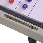 Close-up of a gaming table with control buttons and game pieces.