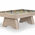 A modern pool table with a light beige wood-grain frame and legs, featuring a sage green felt surface with several colorful billiard balls, shown on a white background.