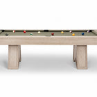 A modern pool table with a light natural wood frame and a green felt playing surface, shown with several billiard balls on a clean white background.