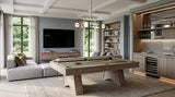 A modern pool table in a spacious, contemporary home bar and living room setting with a sectional sofa, TV, bookshelves, and a wine cooler.