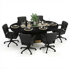 Round dining table set with black chairs on a white background
