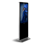 LEDScopic 55" 4K kiosk displays a woman in blue dress, standing on a metal base.