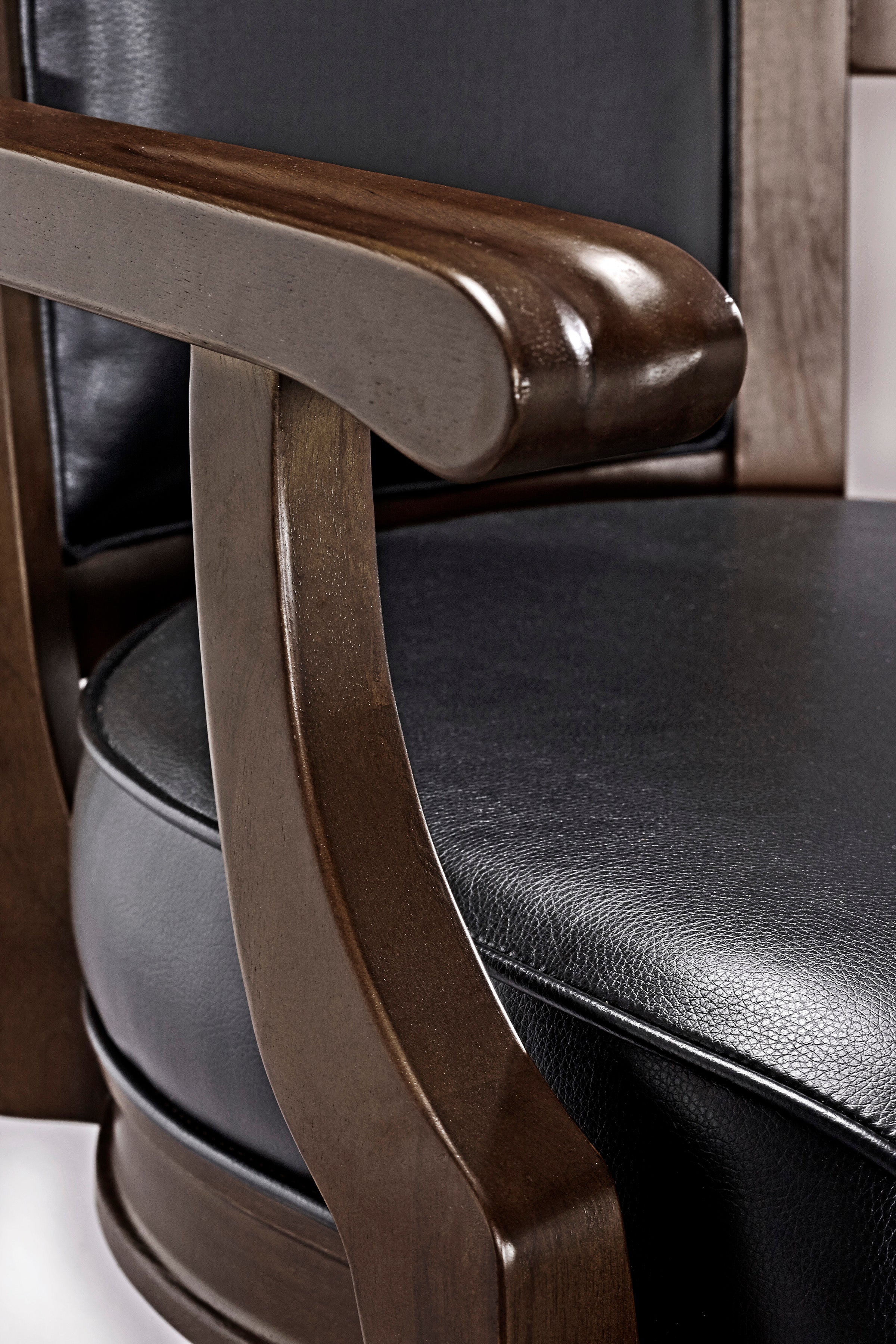 Close-up of the Brunswick Billiards Centennial Game Table in Espresso’s wooden armrest and surface.