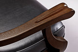 Close-up of wooden armrest and black leather seat on Brunswick Centennial Game Table in Espresso.