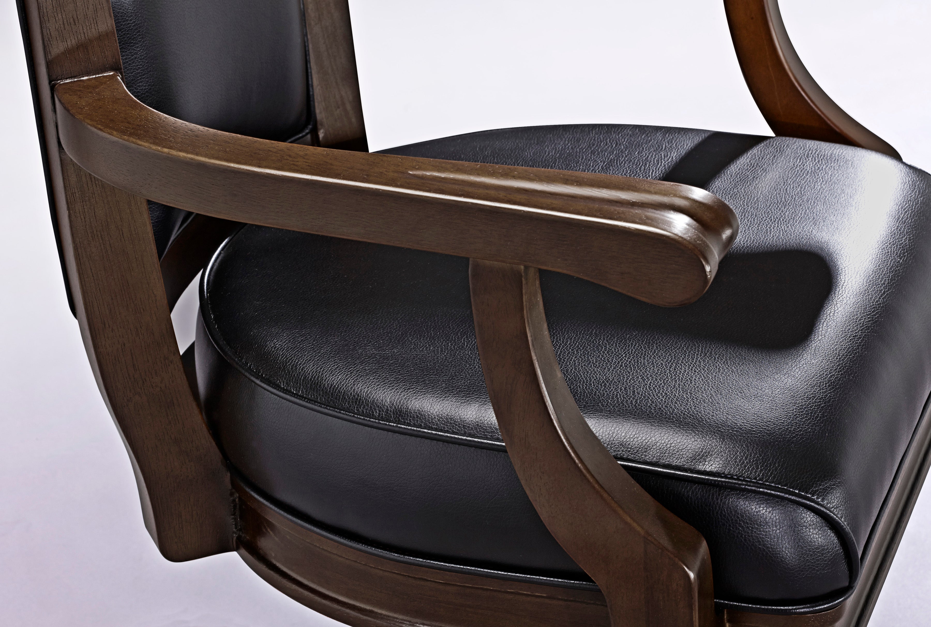 Brunswick Billiards Centennial Game Table in Espresso with black leather-cushioned wooden chairs.