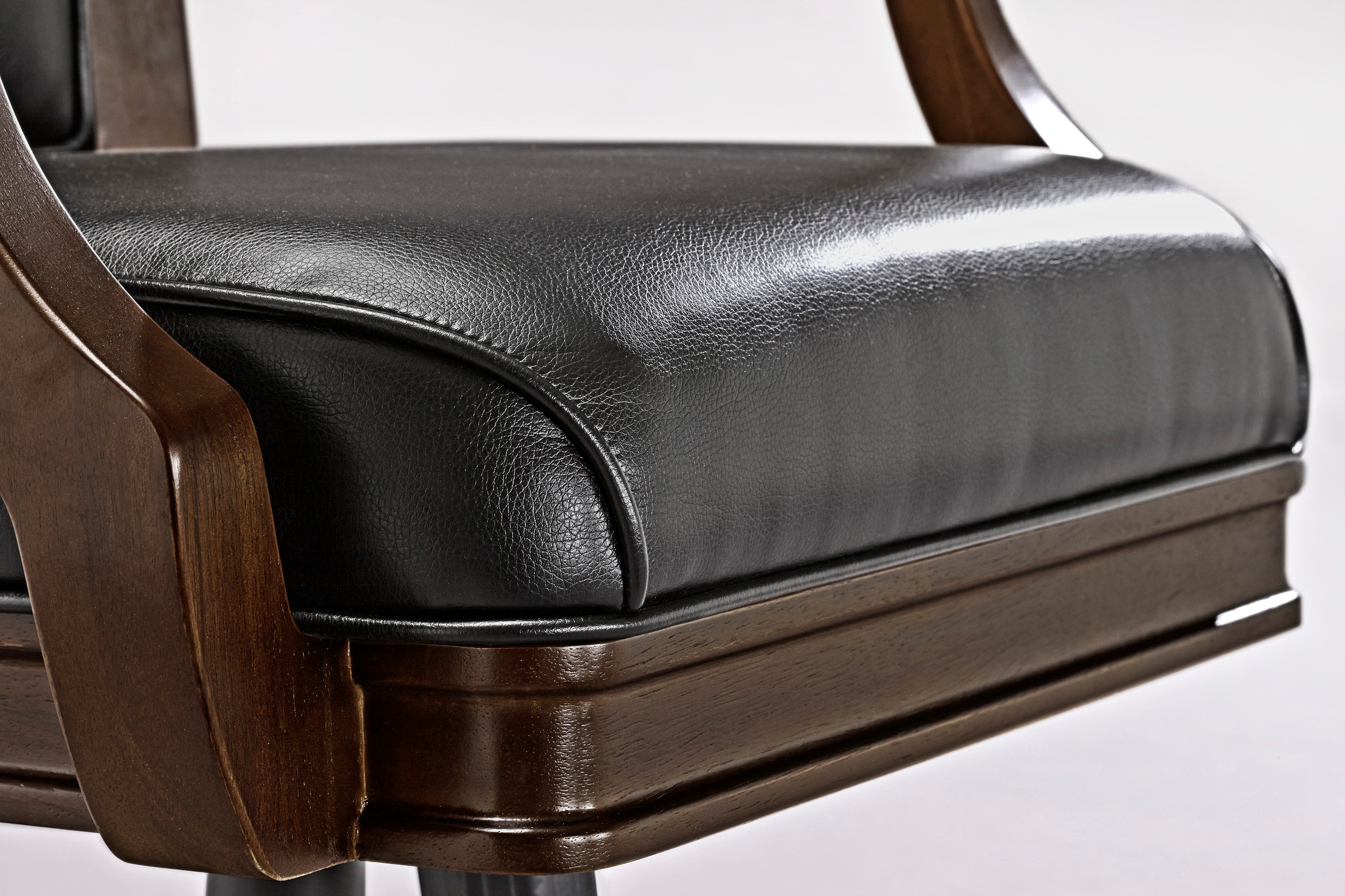 Close-up of Brunswick Billiards Centennial Game Table in Espresso with black leather chair cushion.