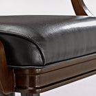 Close-up of Brunswick Billiards Centennial Game Table in Espresso with black leather chair cushion.