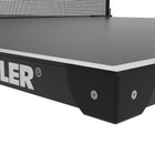 Close-up of a Kettler table tennis table showing the black side panel with the white KETTLER logo, the dark playing surface, and part of the net against a white background.