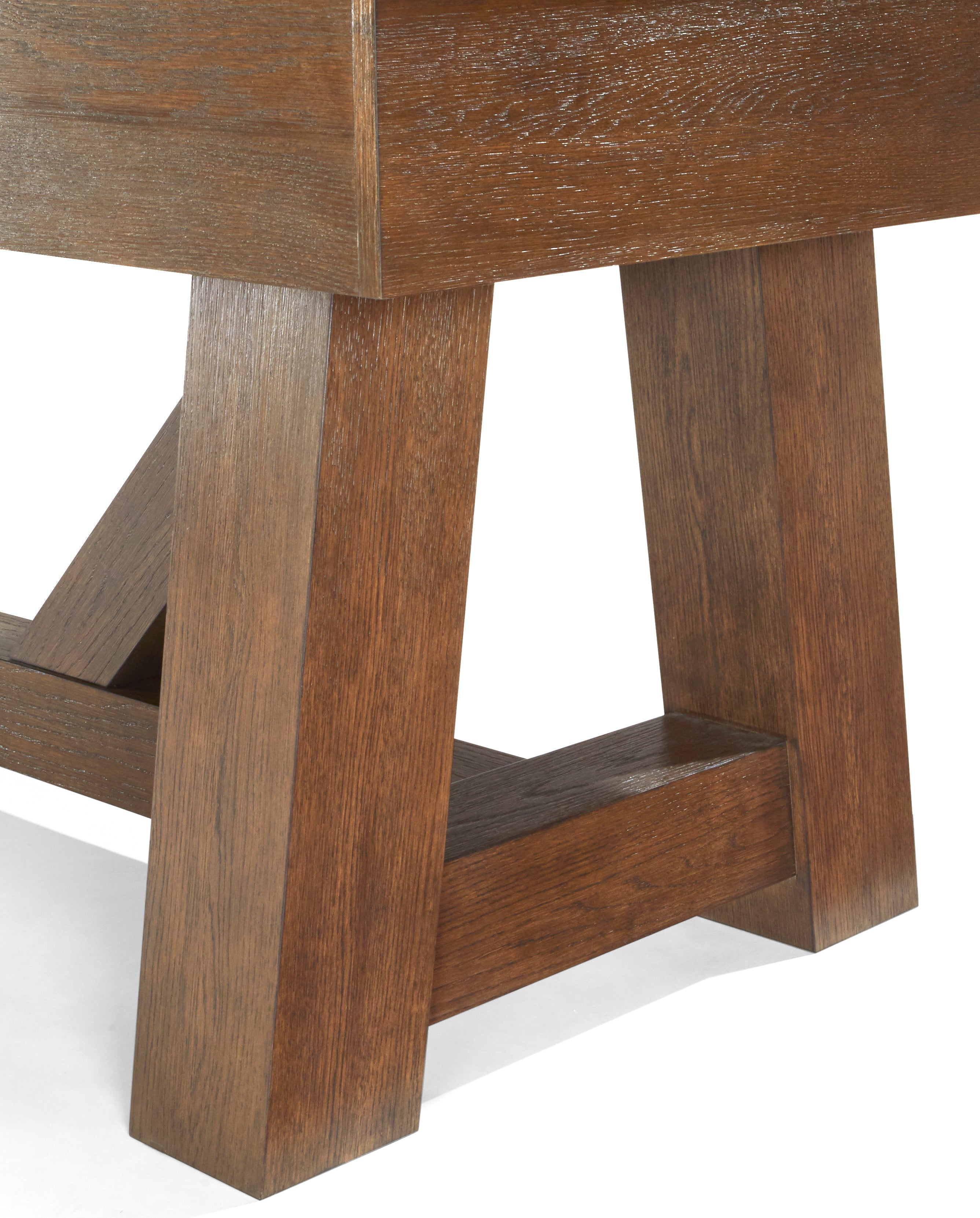 Close-up of angled wood legs on Brunswick Billiards Botanic 12' Shuffleboard Table, Rustic Brown.