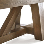 Close-up of Brunswick Billiards Botanic 12' Shuffleboard Table legs in rustic dark brown.