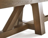 Close-up of Brunswick Billiards Botanic 12' Shuffleboard Table legs in rustic dark brown.