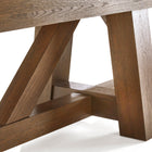Close-up of Brunswick Billiards Botanic 12' Shuffleboard Table legs in rustic dark brown.