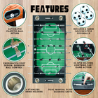 Foosball table with features highlighted on a wooden background