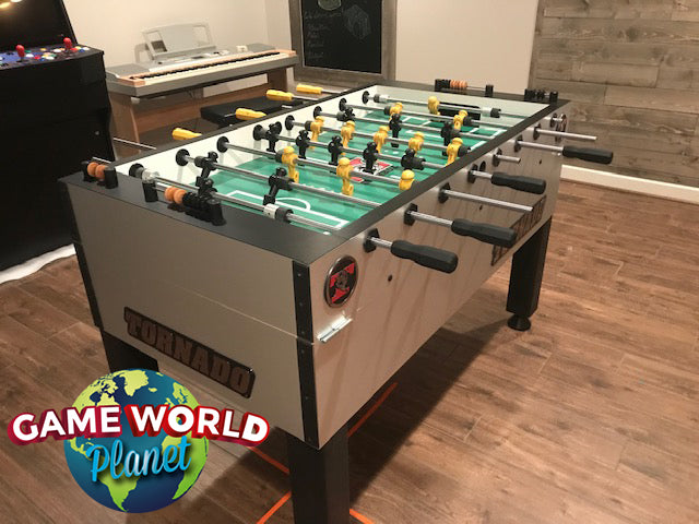 Tornado Tournament Competition T-3000 Foosball Table in silver, shown in a game room setting.