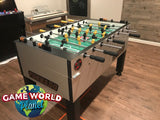 Tornado Tournament Competition T-3000 Foosball Table in silver, shown in a game room setting.