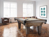 A Brunswick Billiards Glenwood 7' Slate Pool Table in Coffee sits in a bright, art-filled room.