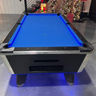Pool table with blue felt surface in a room decorated for Christmas.
