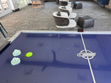 Dynamo 8' Pro Style Air Hockey Table with Dyna-Blast blower and two paddles in lounge area.