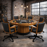 Round poker table with chairs in a room with brick walls and large windows.