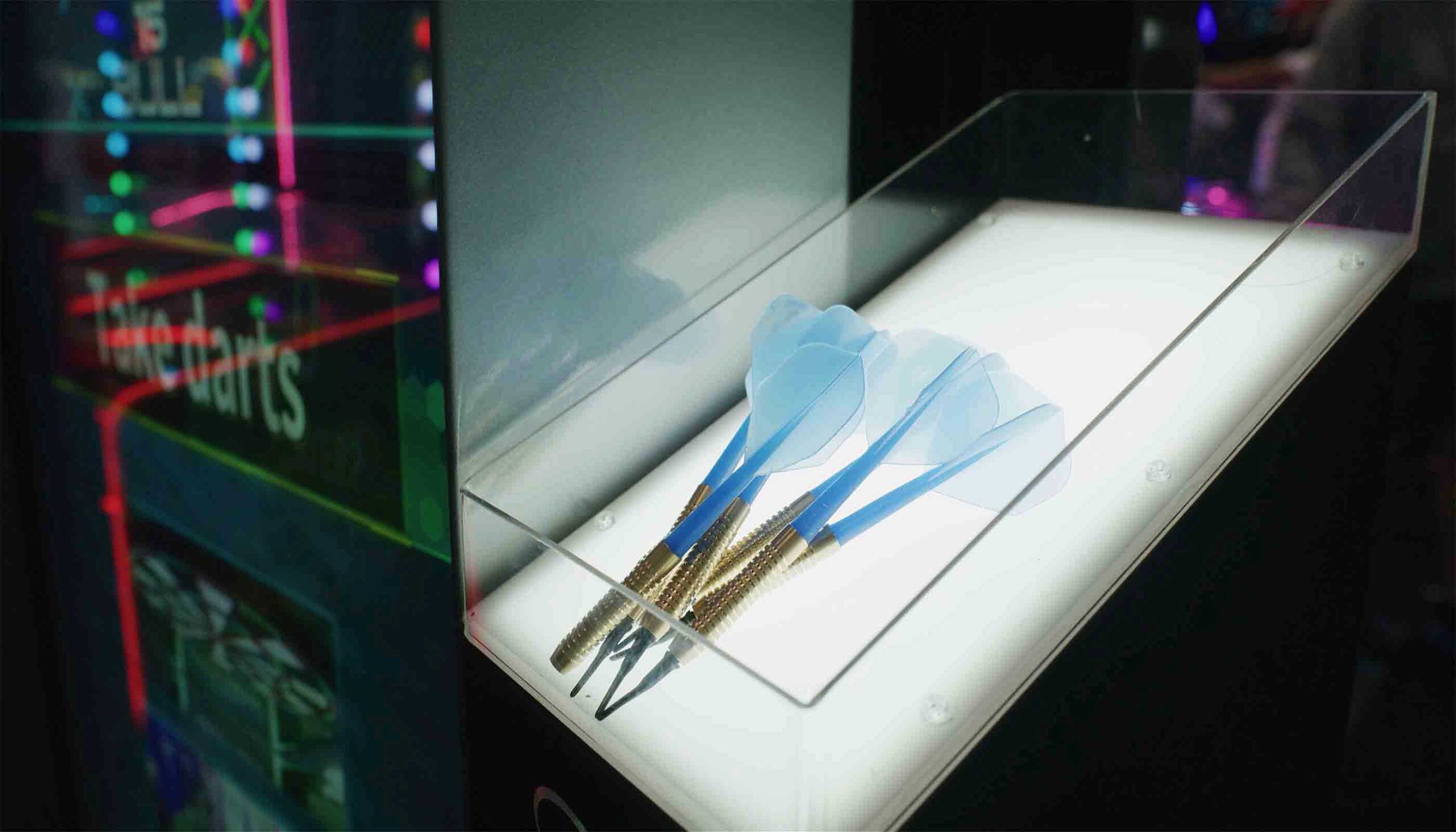 Three blue darts on a stand with a blurred background