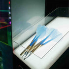 Three blue darts on a stand with a blurred background