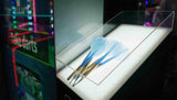 Three blue darts on a stand with a blurred background