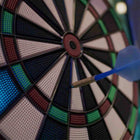 Dart hitting a target with colorful sections on a dark background