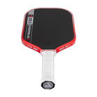 Red and black pickleball paddle with white handle on a white background