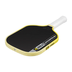 Pickleball paddle with black surface and yellow edges on a white handle against a black background