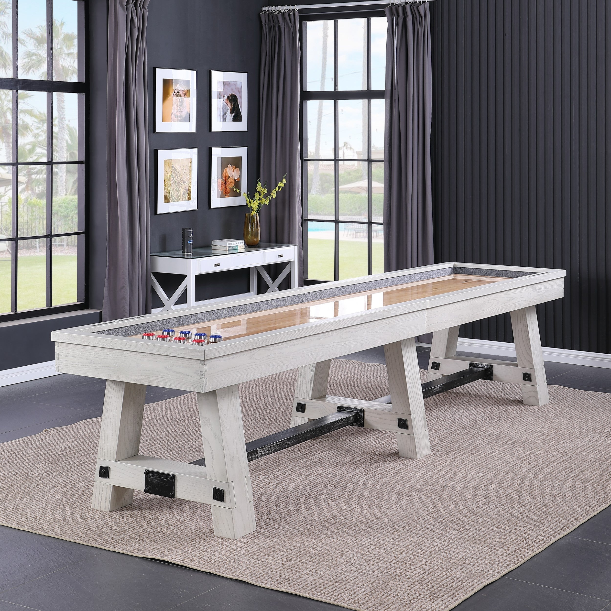A Playcraft 16' Yukon Pro-Style Shuffleboard Table in Northern Drift sits on a rug.