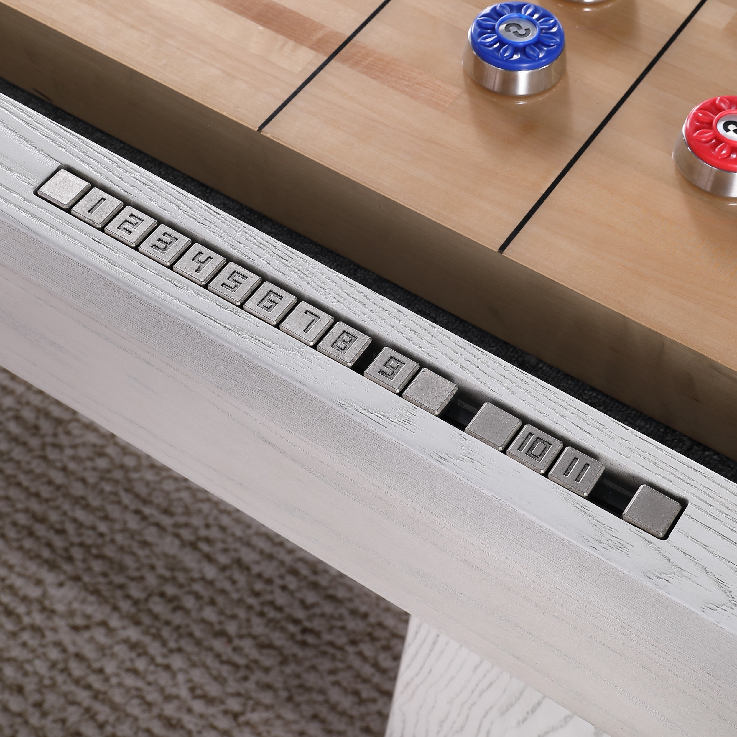 Close-up of Playcraft 16' Yukon Pro-Style Shuffleboard Table scoring sliders on white surface.