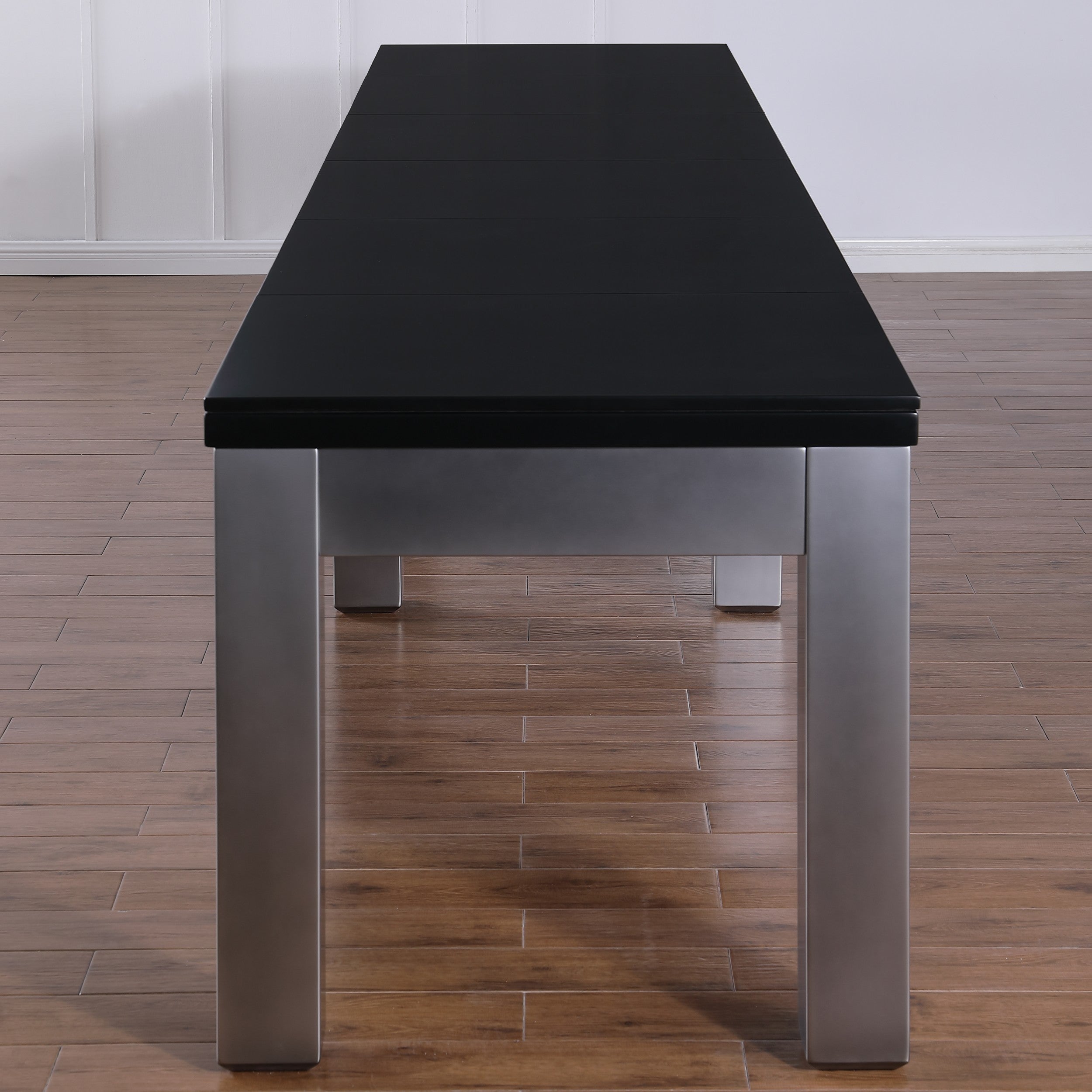 Playcraft Monaco 12' Pro-Style Shuffleboard Table by Playcraft, black with metal legs on wood floor.