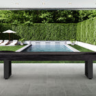 Covered outdoor bench on a patio, with an American Heritage Lanai 9' Shuffleboard Table nearby.