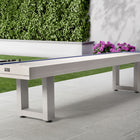An American Heritage Lanai 12' Outdoor Shuffleboard Table in Pearl White sits near flowers.