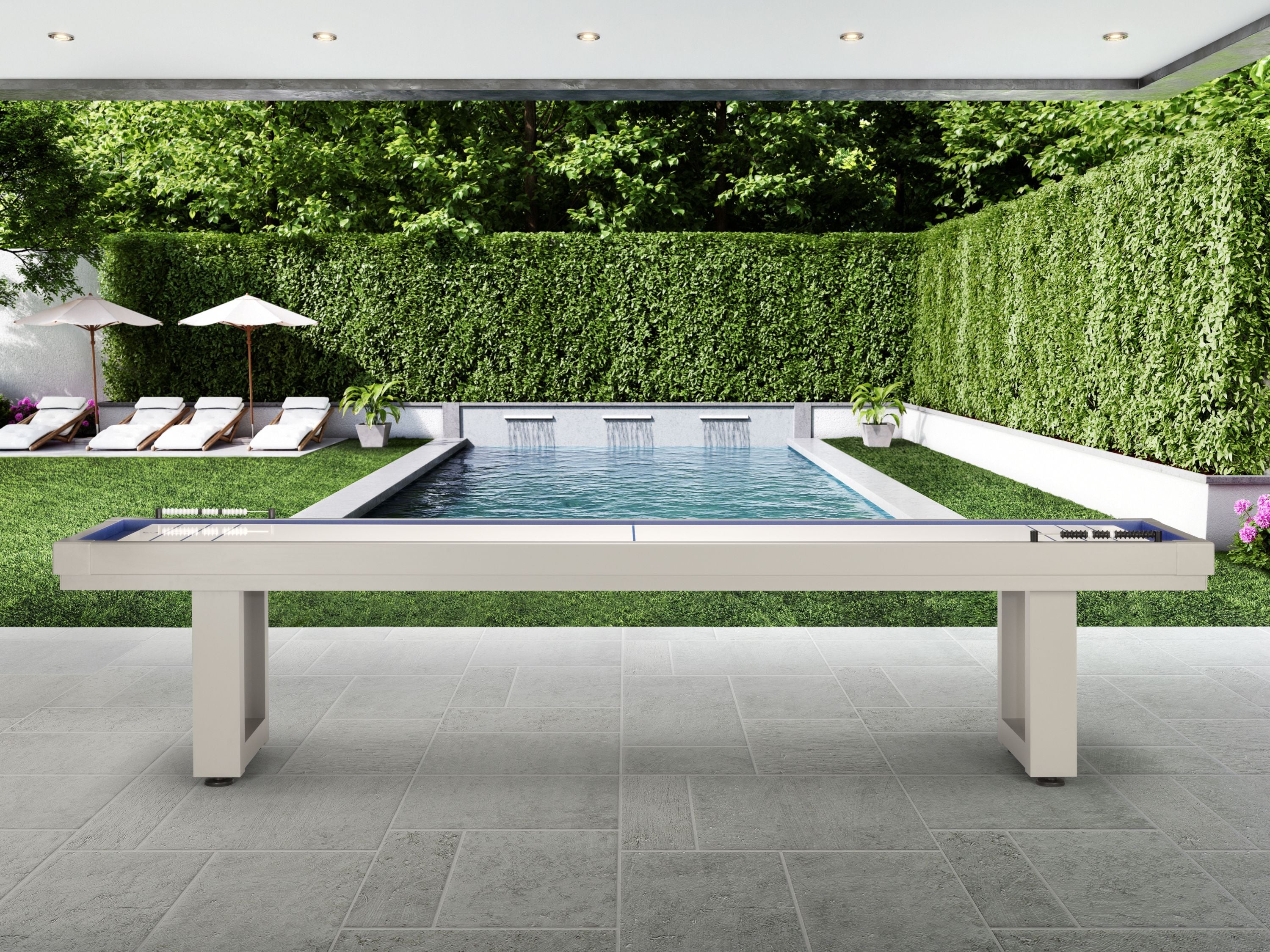 An American Heritage Lanai 12' Outdoor Shuffleboard Table in Oyster Grey sits by the pool.