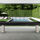Modern pool area with lounge chairs and an American Heritage Lanai 12' Shuffleboard Table.