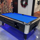 Pool table with blue felt surface in a room decorated for Christmas.