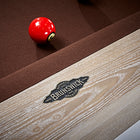 A red billiard ball on a Brunswick Billiards Matanza 8' Slate Pool Table in Sandwashed.