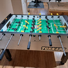 A Tornado Tournament Competition T-3000 Silver Foosball Table stands on a wooden floor.