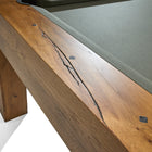Close-up of Brunswick Billiards Parsons 8' Pool Table corner shows natural wood grain and cracks.