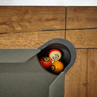 Top view of a Brunswick Billiards Parsons 8' Pool Table corner pocket with four billiard balls.