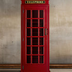 The RAM Game Room Old English Telephone Booth Cue Holder stands by a plain, light brown wall.