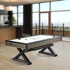 A modern kitchen and living area with a Brunswick Billiards Premier Air Hockey Table and city views.